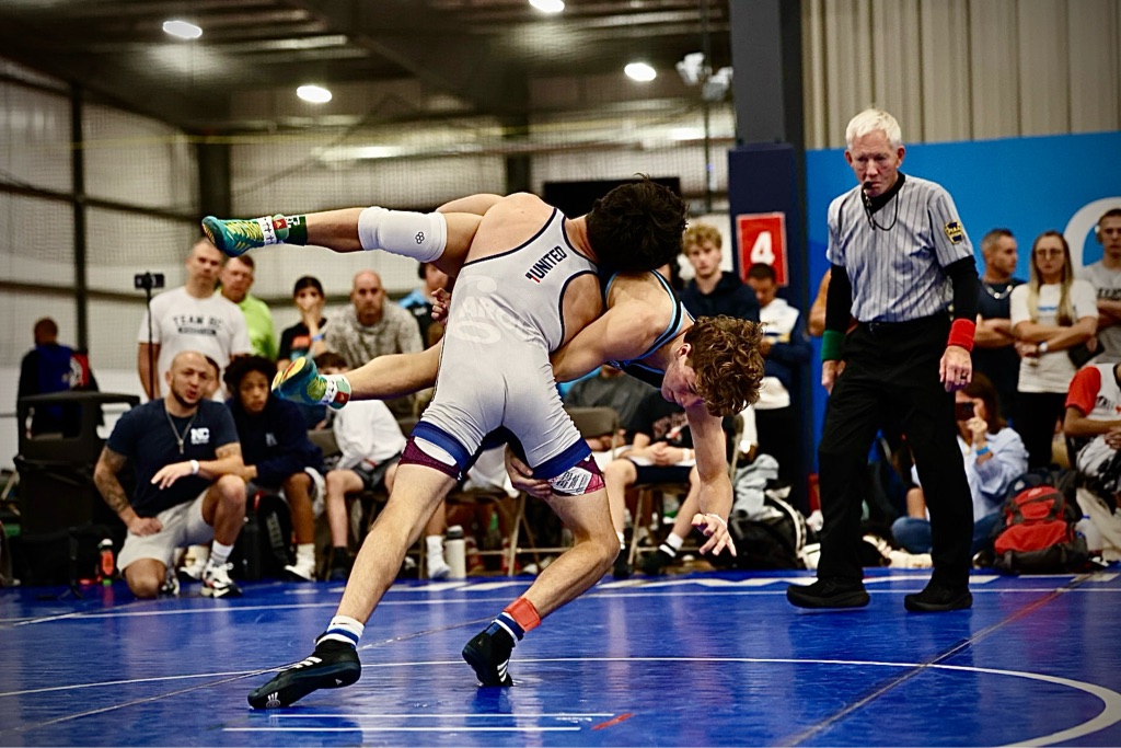 Bentley Sly in intense wrestling action at UCD 2025