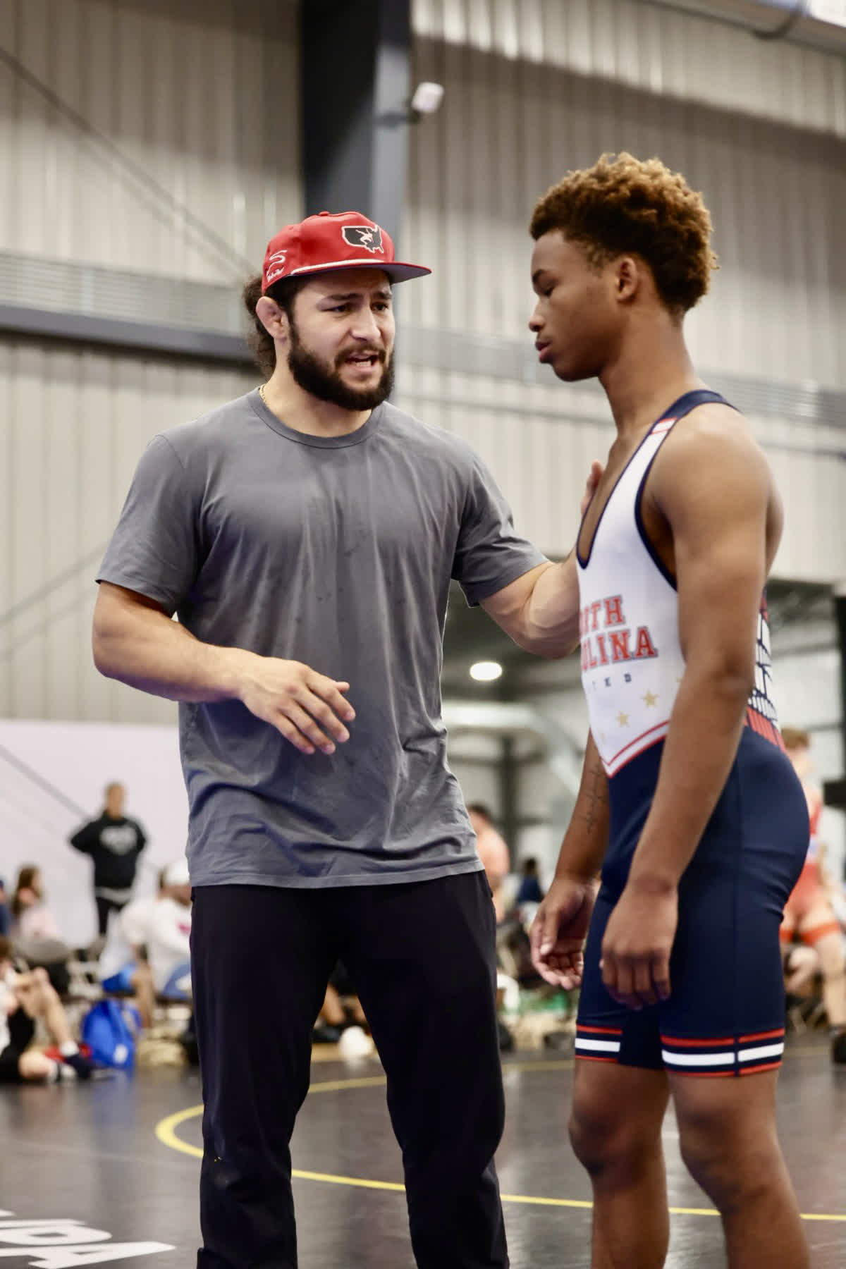 Coach giving instruction to Jekai at UCD 2025
