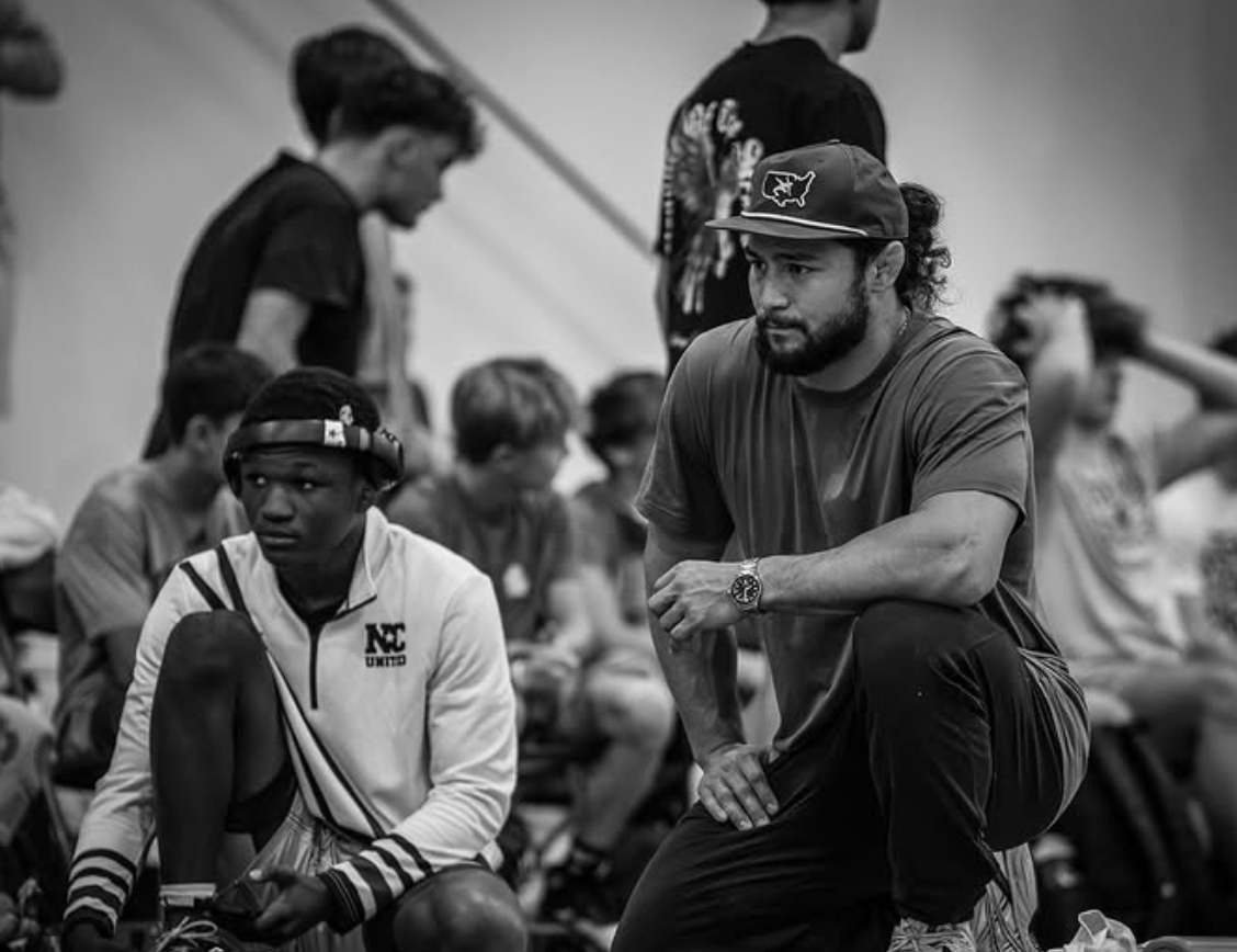 Coach and wrestler conversation - black and white