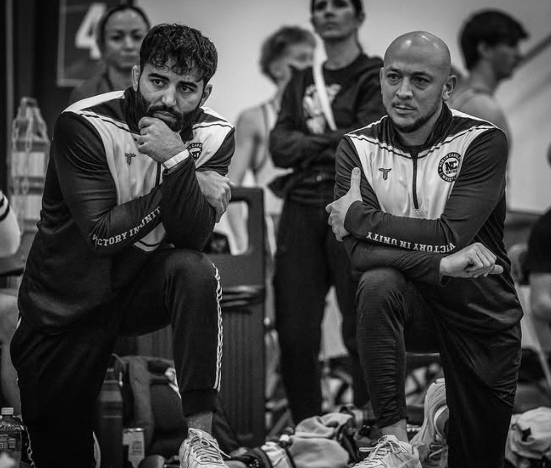 NC United coaches observing matches - black and white